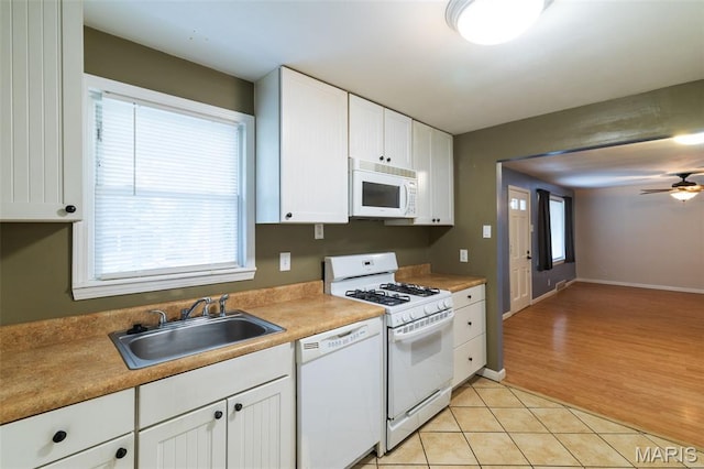 8217 Buchanan Ave, Saint Louis, MO 63114 - kitchen featuring white appliances, white cabinets, ceiling fan, light tile patterned floors, and light countertops