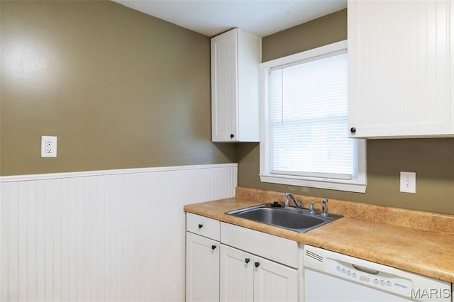 8217 Buchanan Ave, Saint Louis, MO 63114 - kitchen featuring dishwasher, white cabinetry, a wainscoted wall, and light countertops