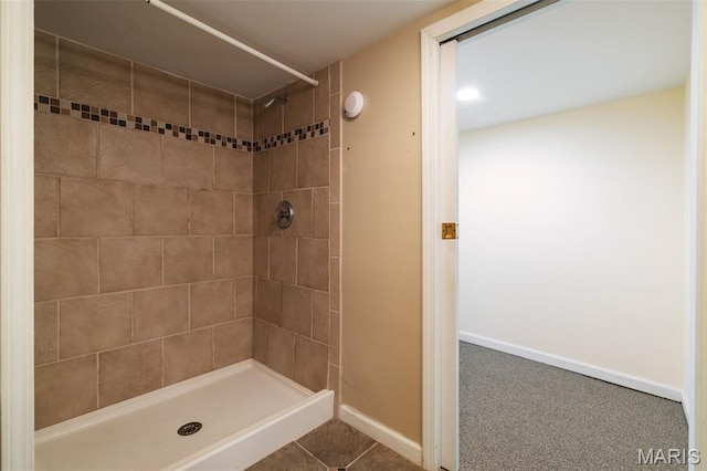 8217 Buchanan Ave, Saint Louis, MO 63114 - bathroom featuring tiled shower and baseboards