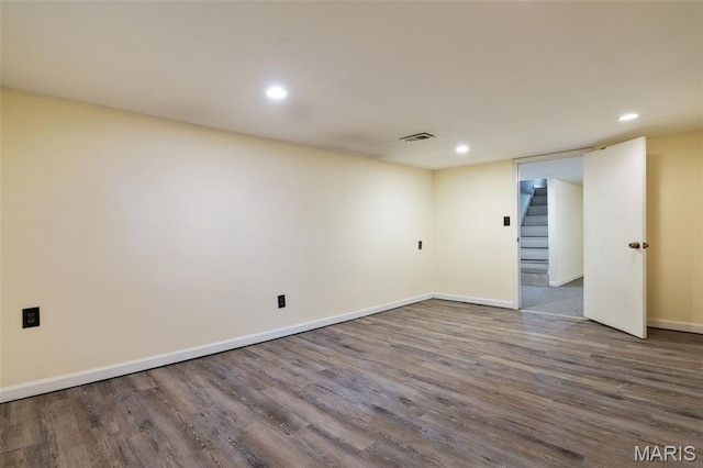 8217 Buchanan Ave, Saint Louis, MO 63114 - spare room with wood finished floors, recessed lighting, and stairs