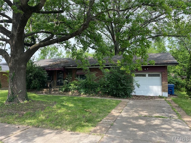 329 Kirk Dr, Ferguson, MO 63135 - view of front facade with brick siding, a front yard, concrete driveway, and an attached garage