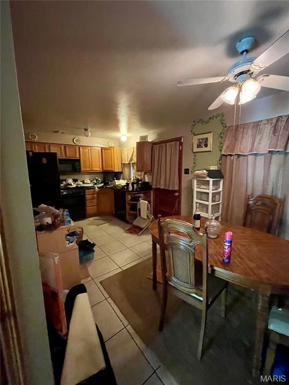329 Kirk Dr, Ferguson, MO 63135 - dining area with light tile patterned flooring and a ceiling fan