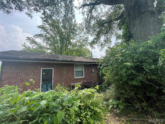 329 Kirk Dr, Ferguson, MO 63135 - rear view of house with brick siding and central AC unit