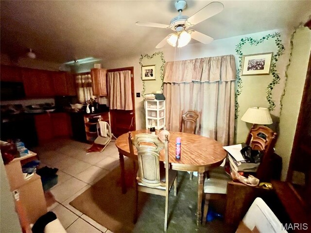 329 Kirk Dr, Ferguson, MO 63135 - dining room featuring tile patterned floors and ceiling fan