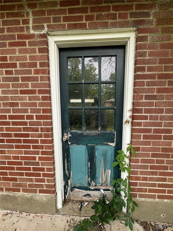 329 Kirk Dr, Ferguson, MO 63135 - property entrance featuring brick siding