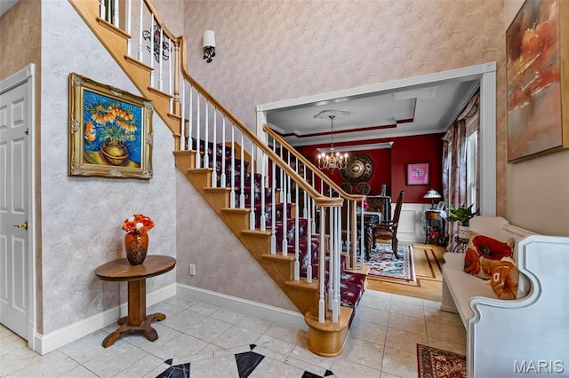807 Caribou Ct, Cape Girardeau, MO 63701 - stairway with a chandelier, tile patterned floors, wallpapered walls, and baseboards