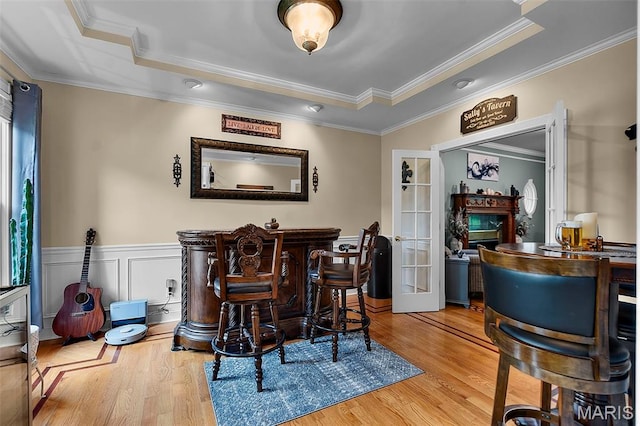 807 Caribou Ct, Cape Girardeau, MO 63701 - bar with a raised ceiling, wood finished floors, french doors, ornamental molding, and a wainscoted wall