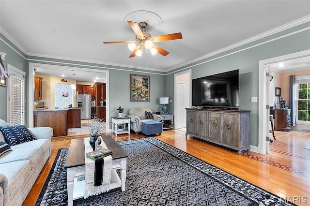 807 Caribou Ct, Cape Girardeau, MO 63701 - living area with light wood-type flooring, ceiling fan, ornamental molding, and baseboards