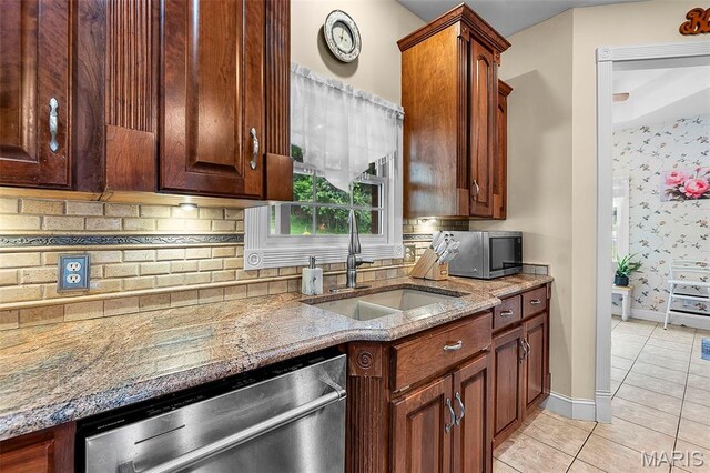 807 Caribou Ct, Cape Girardeau, MO 63701 - kitchen with appliances with stainless steel finishes, a sink, light tile patterned flooring, light stone countertops, and backsplash