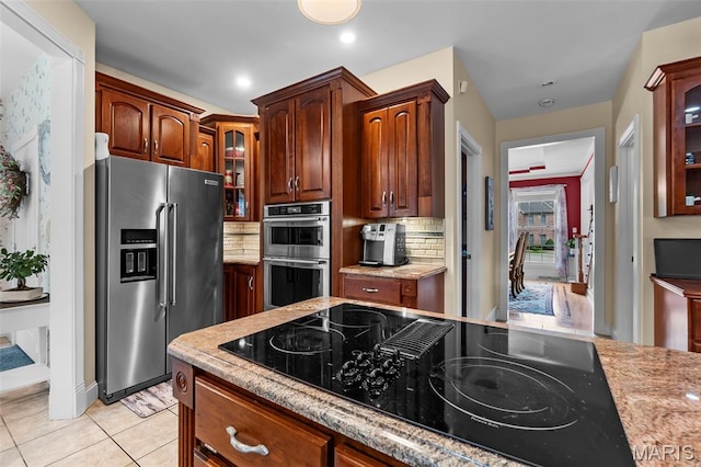 807 Caribou Ct, Cape Girardeau, MO 63701 - kitchen featuring appliances with stainless steel finishes, decorative backsplash, glass insert cabinets, and light tile patterned flooring