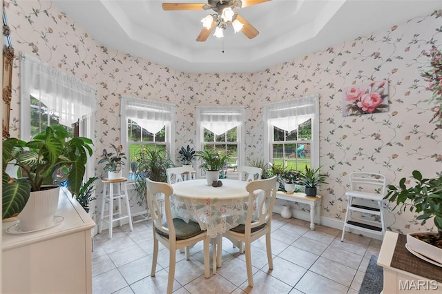 807 Caribou Ct, Cape Girardeau, MO 63701 - dining area with wallpapered walls, ceiling fan, a raised ceiling, healthy amount of natural light, and light tile patterned floors