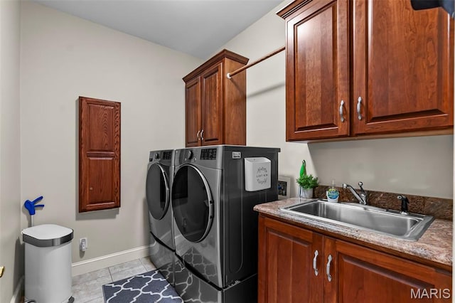 807 Caribou Ct, Cape Girardeau, MO 63701 - laundry room with washer and clothes dryer, cabinet space, baseboards, and light tile patterned floors
