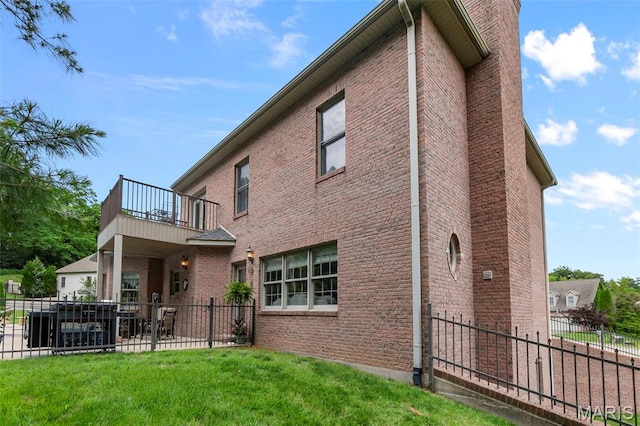 807 Caribou Ct, Cape Girardeau, MO 63701 - rear view of house featuring a balcony, brick siding, and a patio