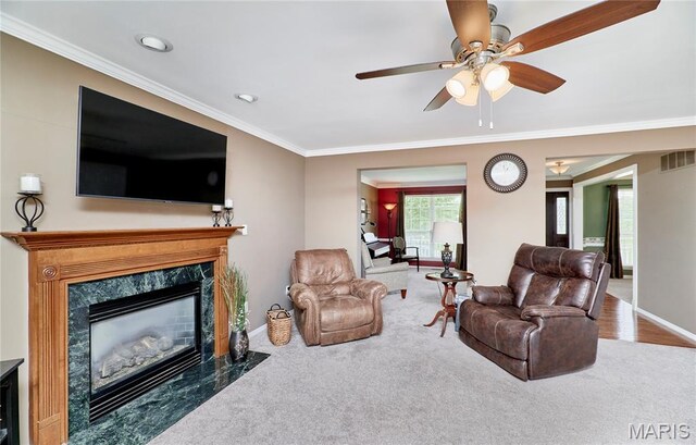 2052 Peine Frst, Wentzville, MO 63385 - living area with a high end fireplace, crown molding, a ceiling fan, and carpet