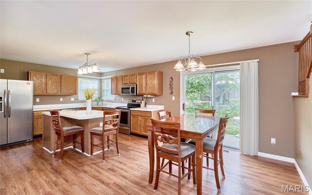 2052 Peine Frst, Wentzville, MO 63385 - kitchen featuring appliances with stainless steel finishes, a chandelier, light countertops, and a center island