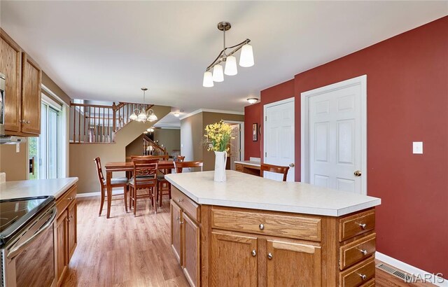 2052 Peine Frst, Wentzville, MO 63385 - kitchen with a chandelier, brown cabinets, light wood finished floors, and electric range
