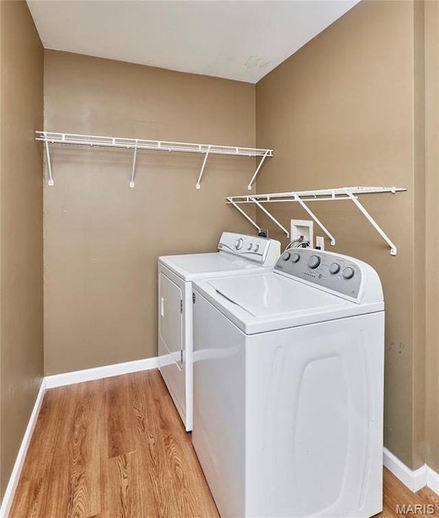 2052 Peine Frst, Wentzville, MO 63385 - laundry area featuring washing machine and clothes dryer and light wood-style flooring