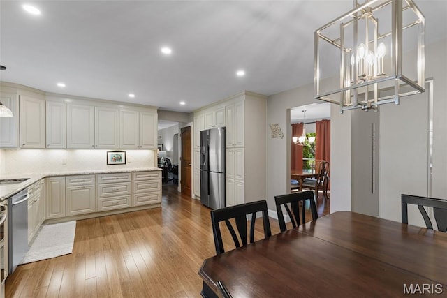 113 Christine Cay Ct, Saint Charles, MO 63304 - dining space with a chandelier, light wood-style flooring, and recessed lighting