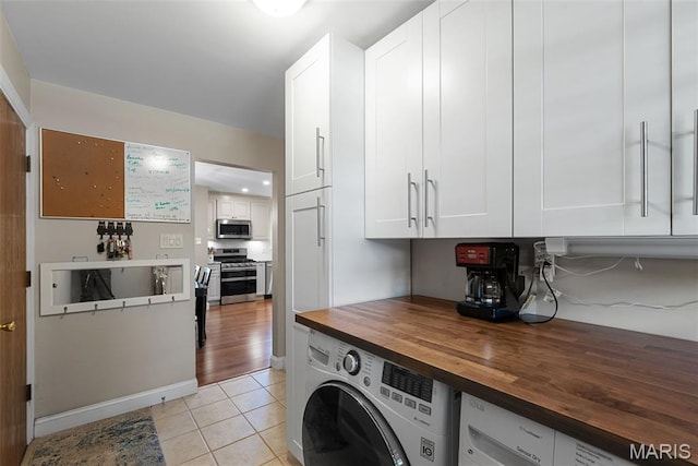 113 Christine Cay Ct, Saint Charles, MO 63304 - laundry room with washer / clothes dryer and light tile patterned flooring
