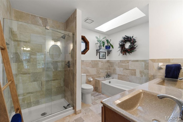 113 Christine Cay Ct, Saint Charles, MO 63304 - bathroom with tile walls, vanity, a stall shower, toilet, and stone tile flooring