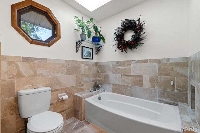 113 Christine Cay Ct, Saint Charles, MO 63304 - full bathroom with tile walls, toilet, a bath, and a skylight