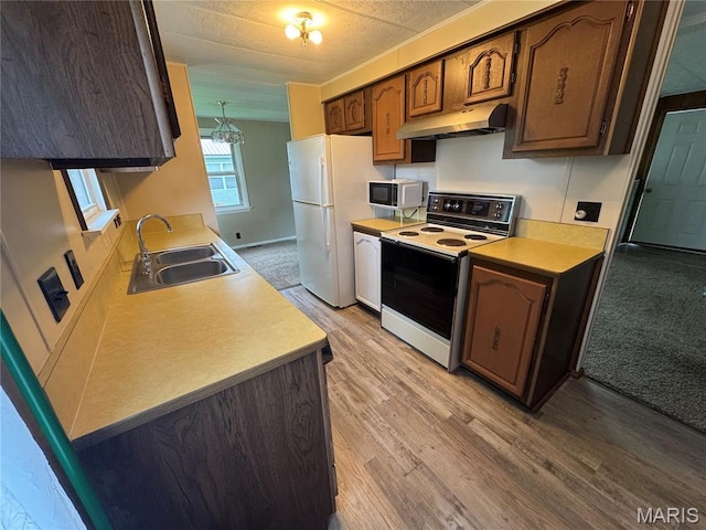 516 S 12th St, Bowling Green, MO 63334 - kitchen featuring under cabinet range hood, electric stove, stainless steel microwave, freestanding refrigerator, and a sink