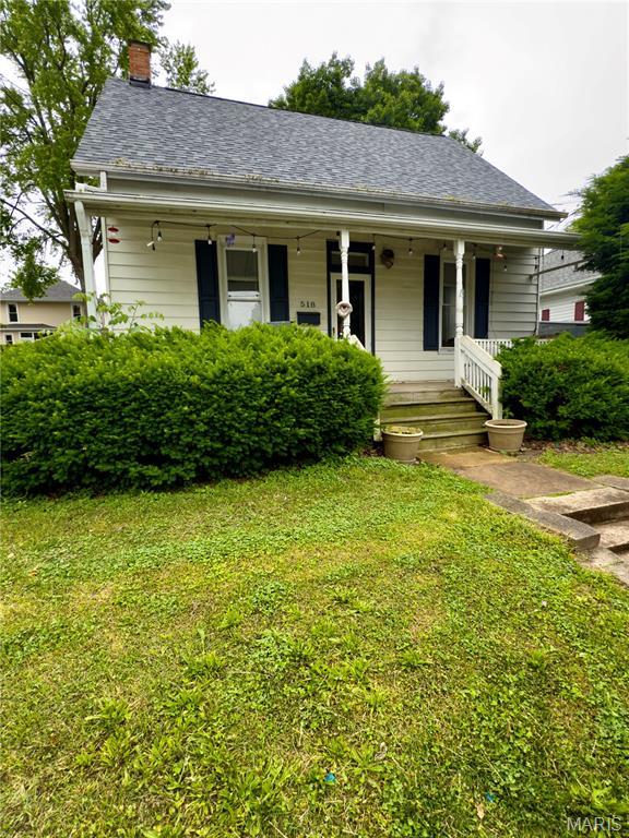 518 Randle St, Edwardsville, IL 62025 - view of front of home with a porch, a front yard, and a chimney