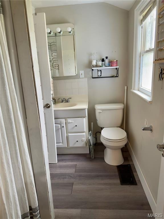 518 Randle St, Edwardsville, IL 62025 - full bathroom with vanity, wood finished floors, and backsplash