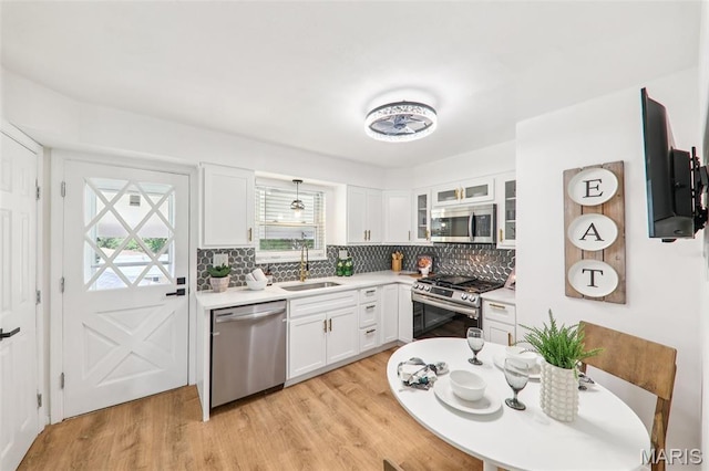 1525 79th St, Saint Louis, MO 63130 - kitchen featuring stainless steel appliances, healthy amount of natural light, and white cabinetry