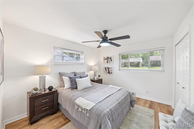 1525 79th St, Saint Louis, MO 63130 - bedroom with multiple windows, a closet, light wood-style floors, and a ceiling fan