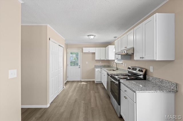 206 6th St, Park Hills, MO 63601 - kitchen with stainless steel appliances, a sink, wood finished floors, under cabinet range hood, and light stone counters