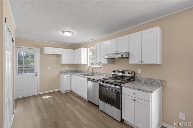 206 6th St, Park Hills, MO 63601 - kitchen with appliances with stainless steel finishes, under cabinet range hood, light wood-style flooring, a textured ceiling, and white cabinets