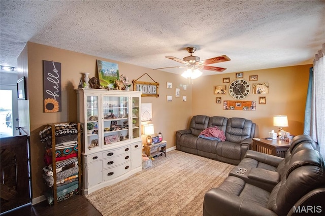 906 E Fairgrounds Ave, Jerseyville, IL 62052 - living area featuring a ceiling fan, a textured ceiling, and baseboards