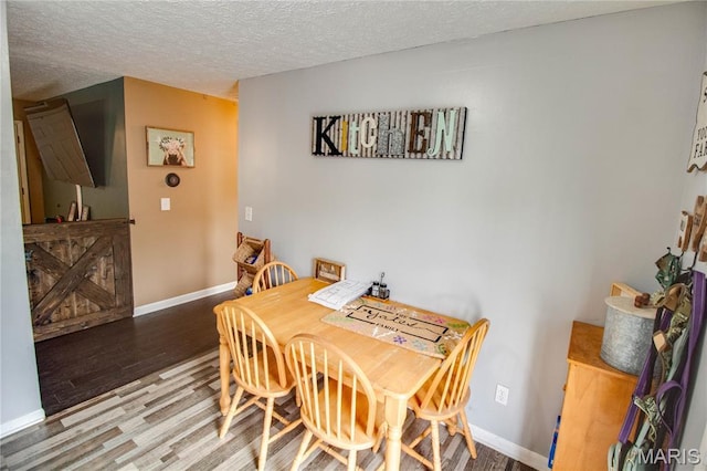 906 E Fairgrounds Ave, Jerseyville, IL 62052 - dining room with wood finished floors, baseboards, and a textured ceiling