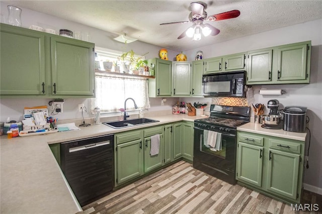 906 E Fairgrounds Ave, Jerseyville, IL 62052 - kitchen featuring black appliances, a sink, green cabinetry, light countertops, and a textured ceiling