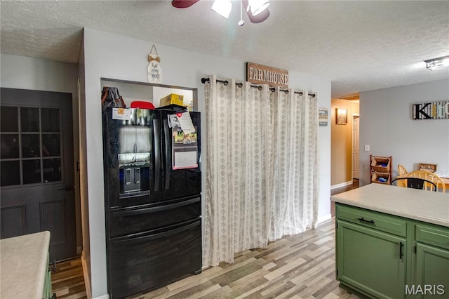 906 E Fairgrounds Ave, Jerseyville, IL 62052 - kitchen featuring green cabinets, black fridge, a textured ceiling, light wood-type flooring, and ceiling fan