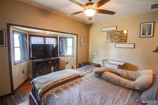 906 E Fairgrounds Ave, Jerseyville, IL 62052 - bedroom featuring wood finished floors, ceiling fan, and baseboards