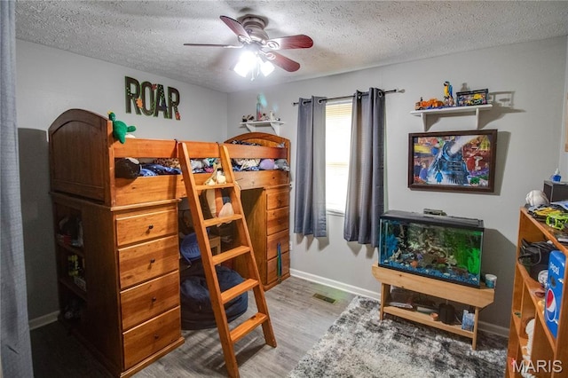 906 E Fairgrounds Ave, Jerseyville, IL 62052 - bedroom with a textured ceiling, wood finished floors, and baseboards