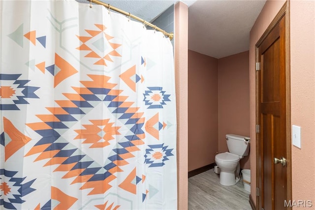 465 County Road 5120, Salem, MO 65560 - bathroom with a textured ceiling, wood finished floors, and a shower with shower curtain