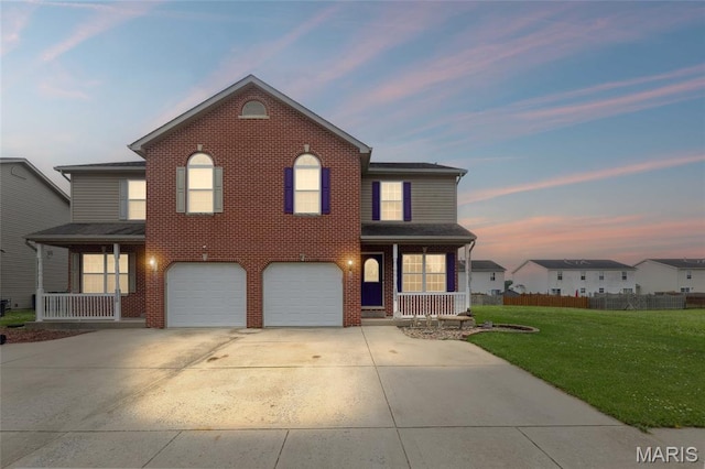 2024 Camrose Green St, Belleville, IL 62220 - traditional home with covered porch, a garage, driveway, and brick siding