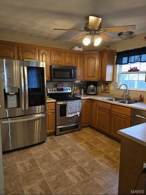 2024 Camrose Green St, Belleville, IL 62220 - kitchen with appliances with stainless steel finishes, a sink, brown cabinets, a ceiling fan, and light countertops