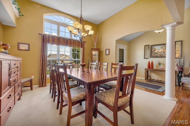 1020 Oak Creek Ln, Waterloo, IL 62298 - dining room featuring arched walkways, ornate columns, baseboards, and a chandelier
