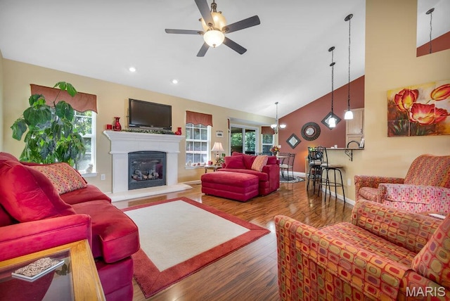 1020 Oak Creek Ln, Waterloo, IL 62298 - living area featuring healthy amount of natural light, ceiling fan, wood finished floors, high vaulted ceiling, and a glass covered fireplace