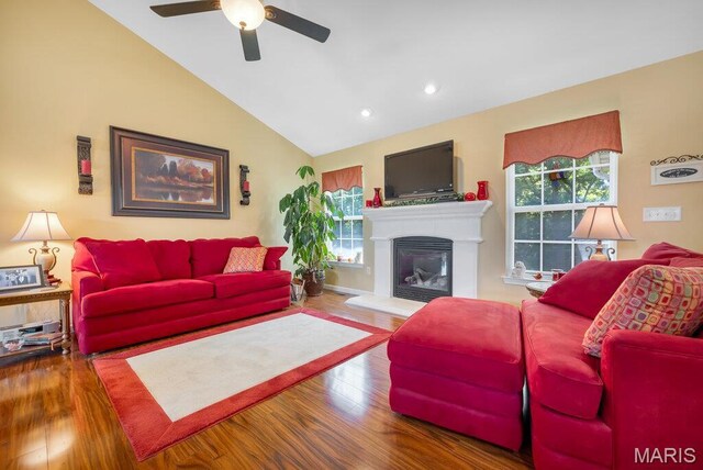 1020 Oak Creek Ln, Waterloo, IL 62298 - living area featuring lofted ceiling, a ceiling fan, wood finished floors, a glass covered fireplace, and recessed lighting