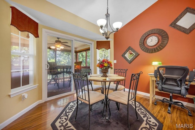 1020 Oak Creek Ln, Waterloo, IL 62298 - dining space with baseboards, wood finished floors, vaulted ceiling, and a chandelier