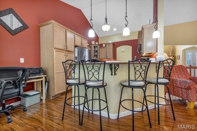 1020 Oak Creek Ln, Waterloo, IL 62298 - kitchen featuring stainless steel appliances, a breakfast bar area, dark wood finished floors, a peninsula, and glass insert cabinets