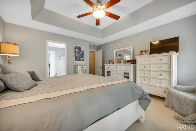 1020 Oak Creek Ln, Waterloo, IL 62298 - bedroom featuring a raised ceiling, light carpet, and ceiling fan