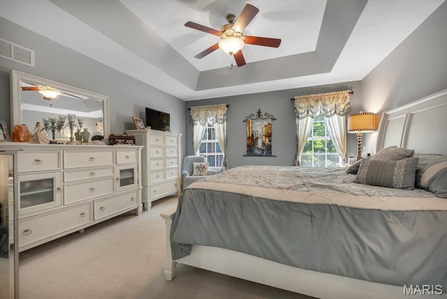 1020 Oak Creek Ln, Waterloo, IL 62298 - bedroom with a tray ceiling, light carpet, and ceiling fan