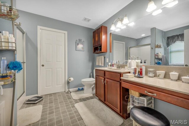 1020 Oak Creek Ln, Waterloo, IL 62298 - bathroom featuring a stall shower, vanity, toilet, baseboards, and tile patterned flooring