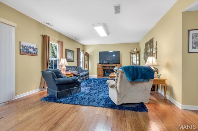 1020 Oak Creek Ln, Waterloo, IL 62298 - living room featuring wood finished floors, baseboards, and a glass covered fireplace